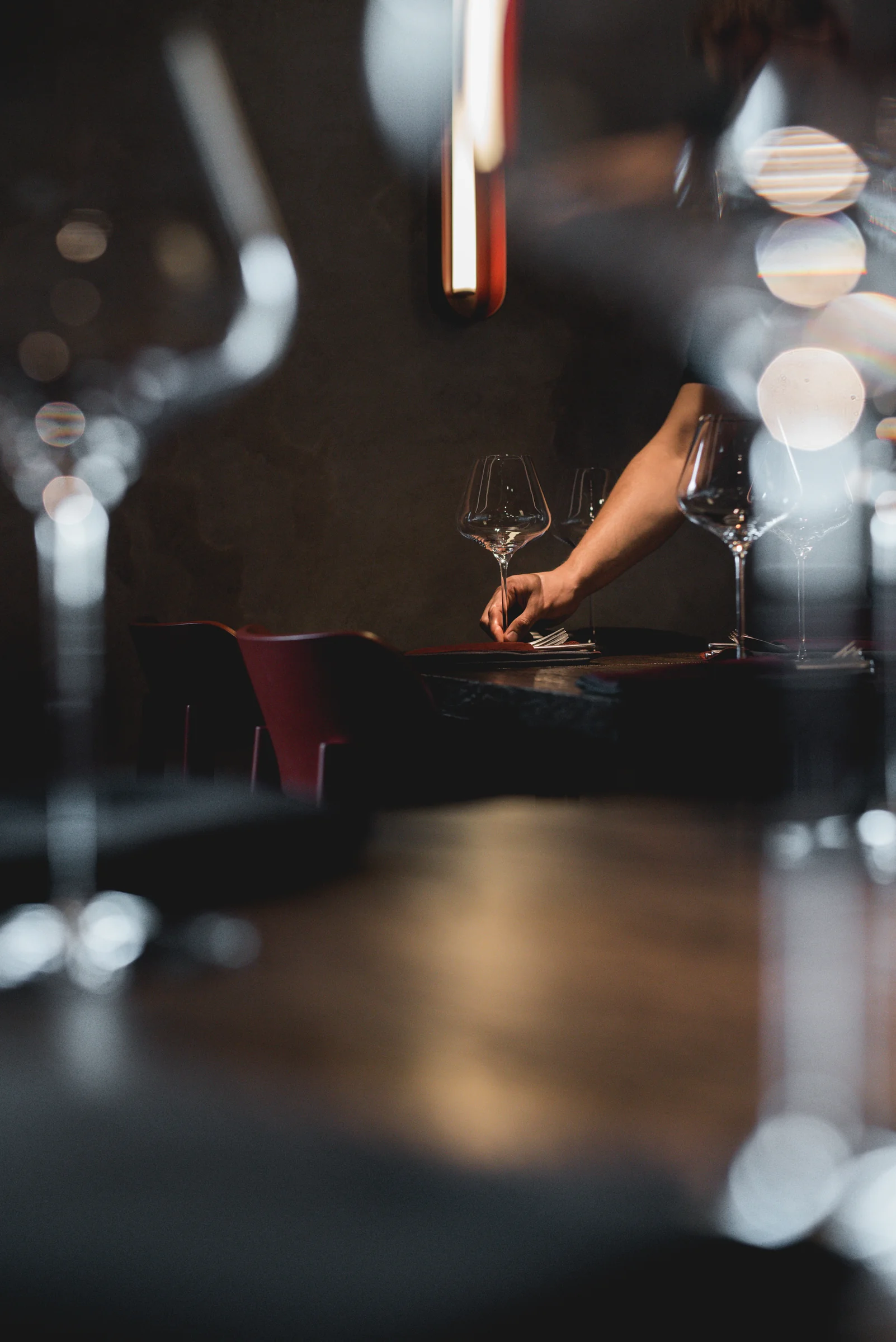 Commons — setting a dining table with wine glasses and warm ambient lighting