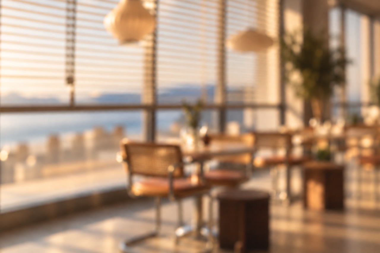 Lineup — softly blurred coastal restaurant with large windows overlooking the water