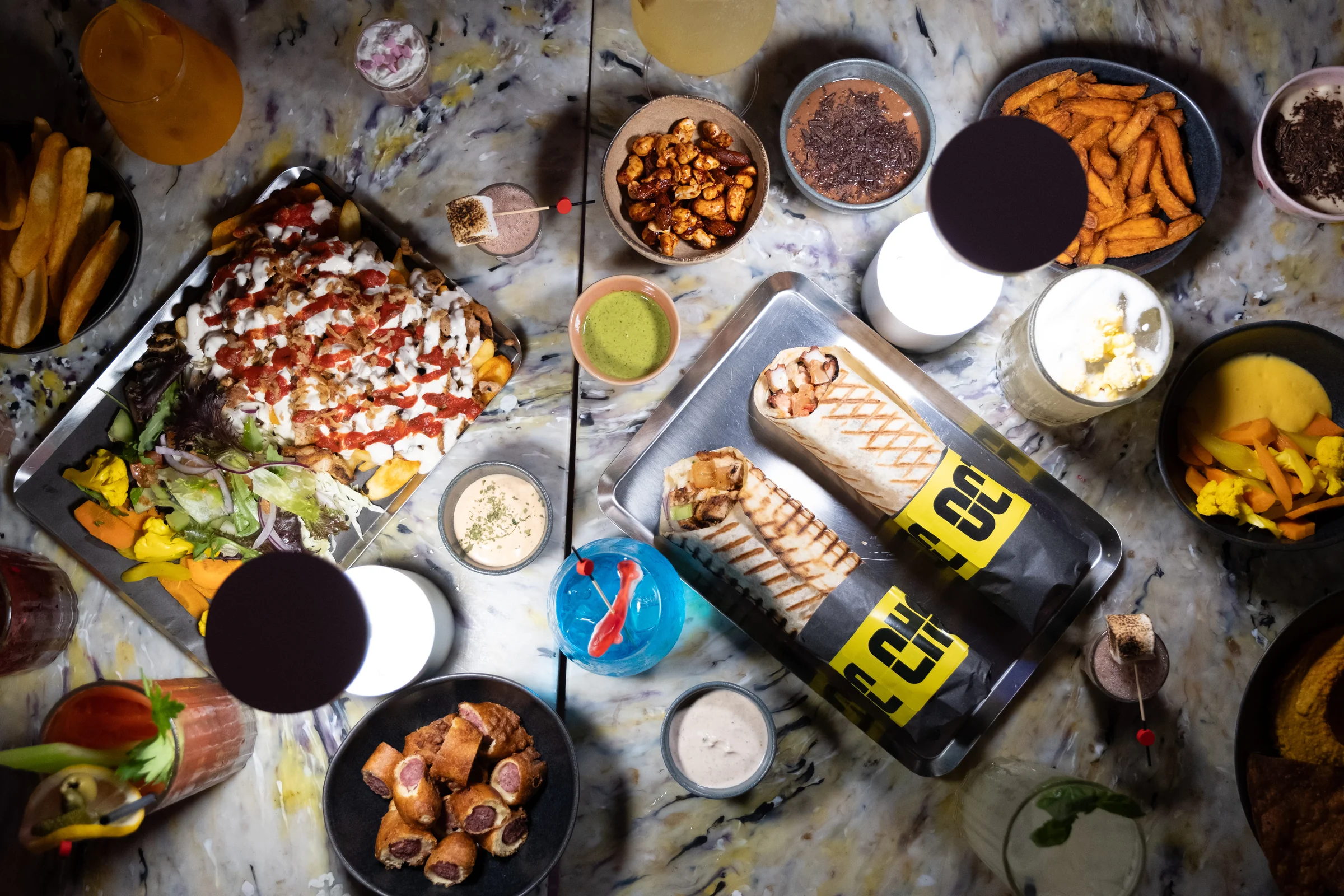 LKS — kebabs, fries, sides and drinks arranged on a table