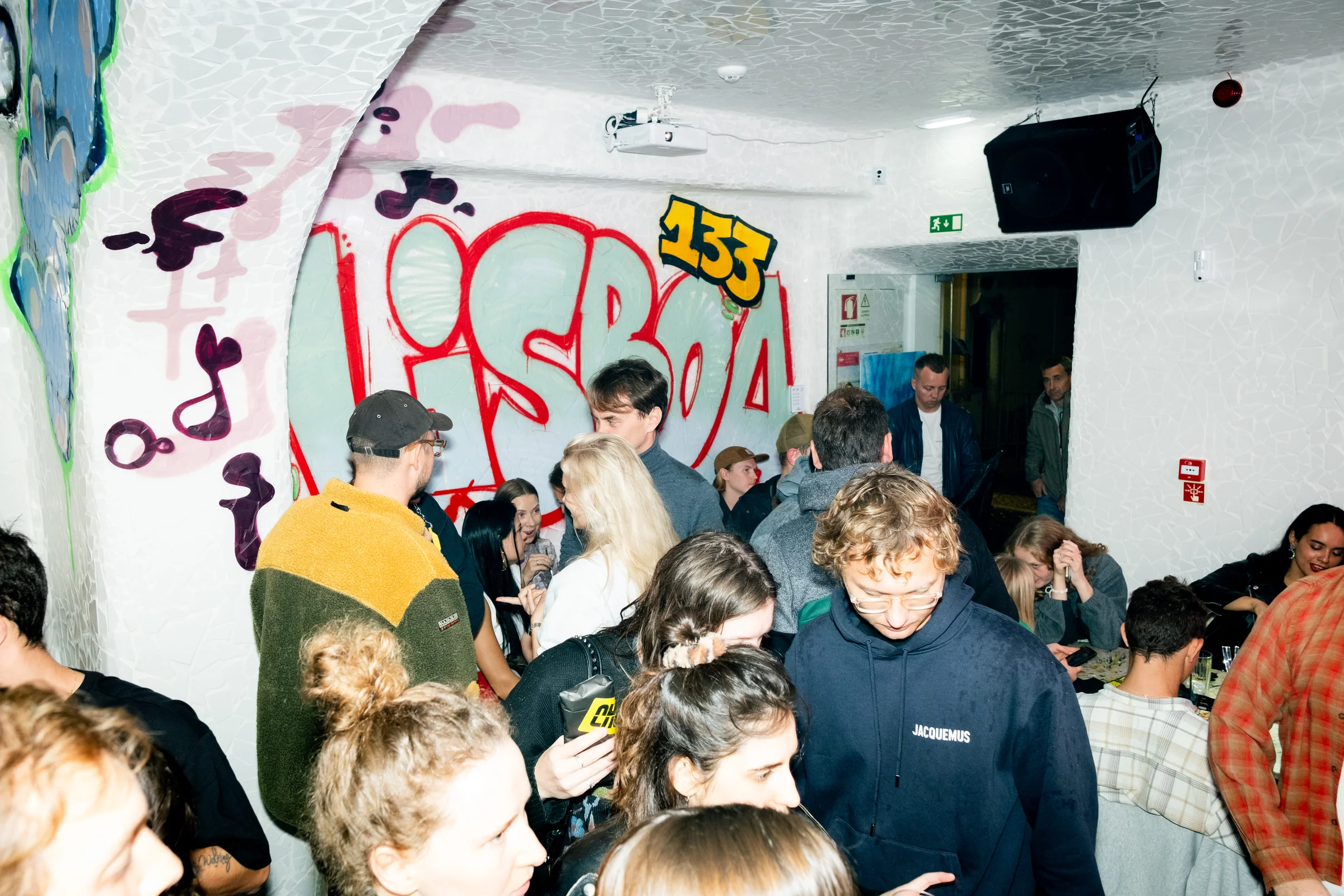 LKS — guests at a party in the graffiti-covered interior