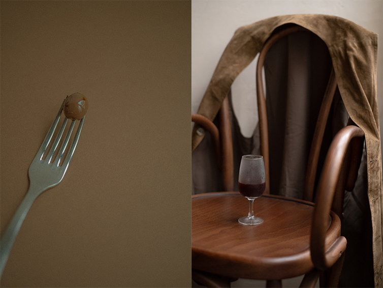 Zula Bistro — olive on a fork and a wine glass on a wooden chair